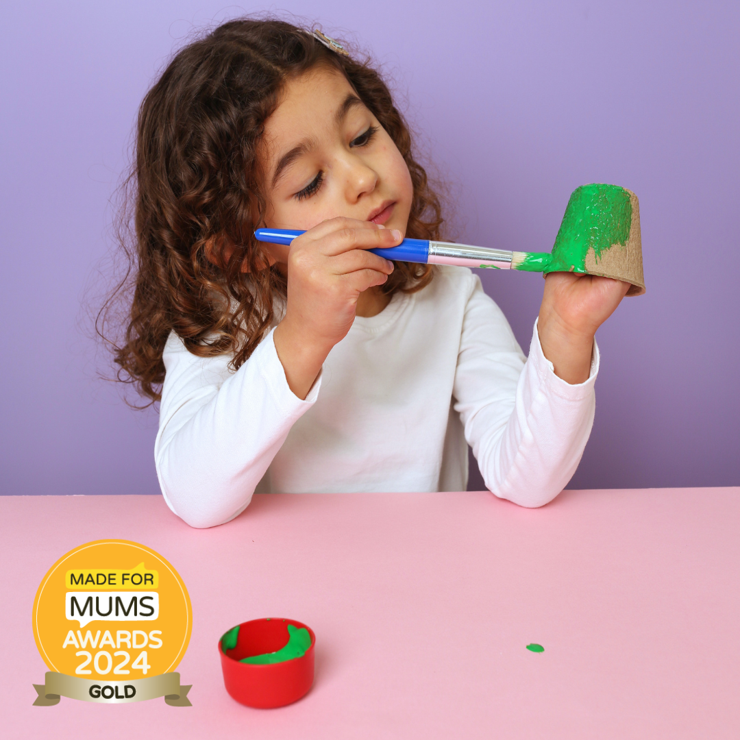 Child playing with a toy resembling a thermometer, with a 'Made for Mums Awards 2024 Gold' badge in the corner.