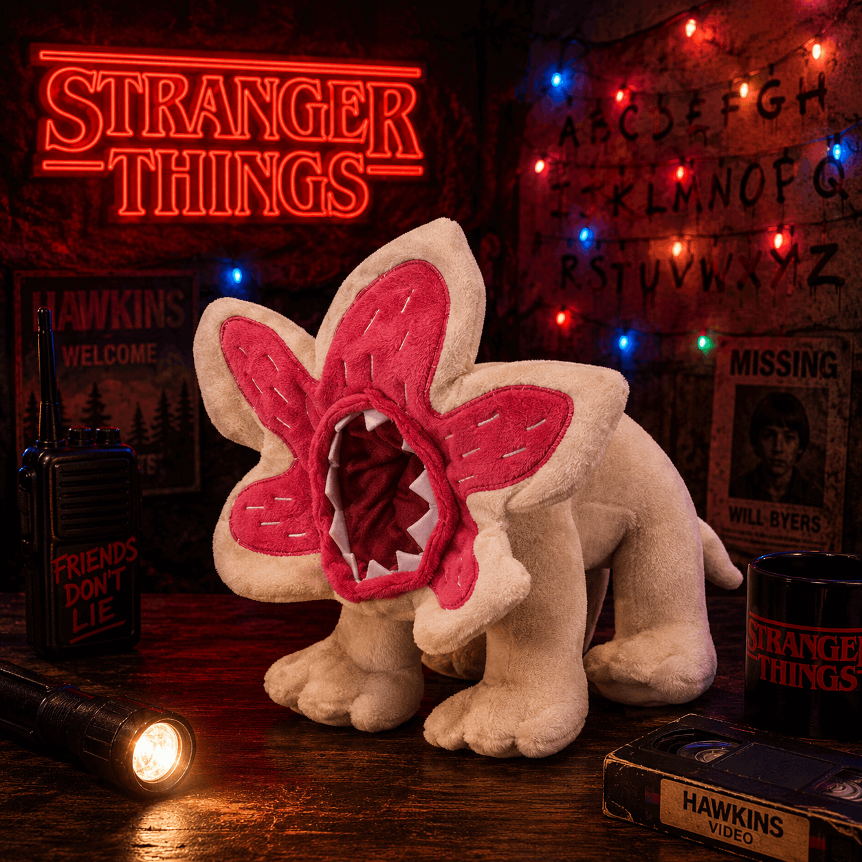 Plush toy with red mouth and ears in front of a Stranger Things neon sign and decor.