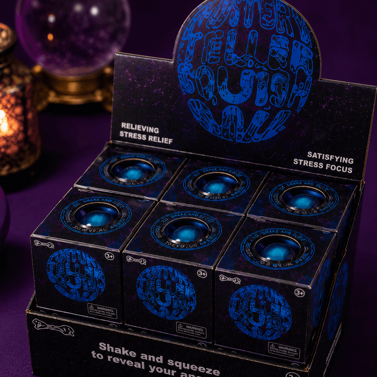 Display of stress relief balls with a branded box on a purple background