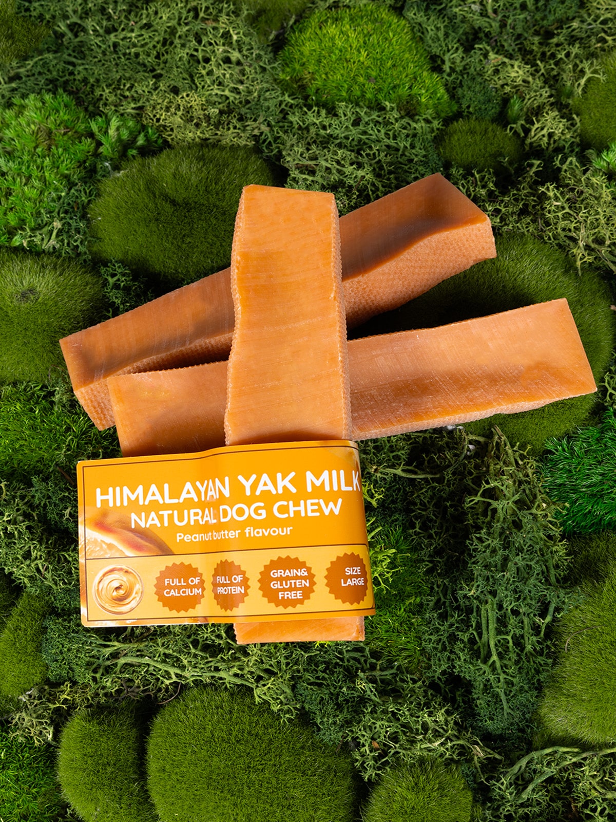 Himalayan Yak Milk Natural Dog Chew packaging on a green moss background