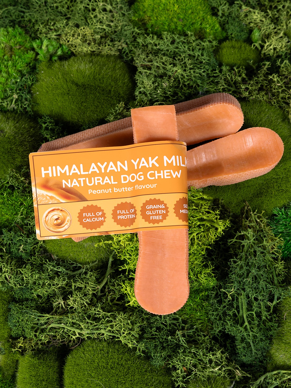 Himalayan Yak Milk natural dog chew with packaging on a green moss background