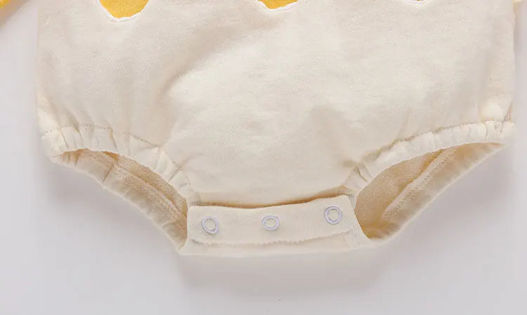 Beige baby diaper with button closures on a white background