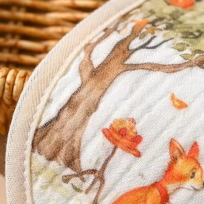 Embroidery hoop with a fox and tree design on fabric.