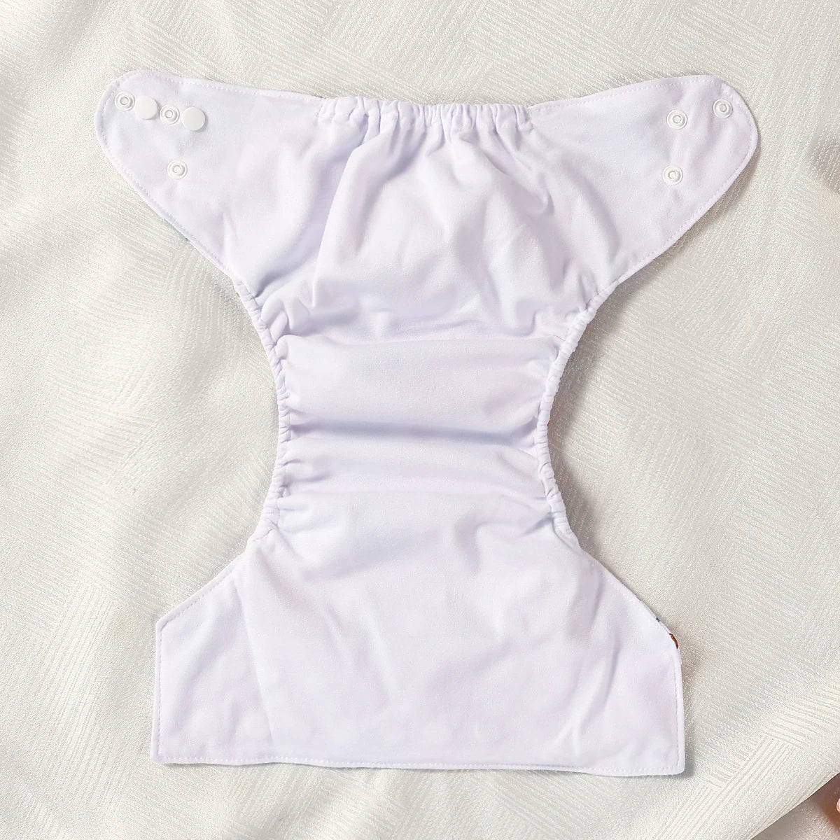 White diaper on a textured beige surface