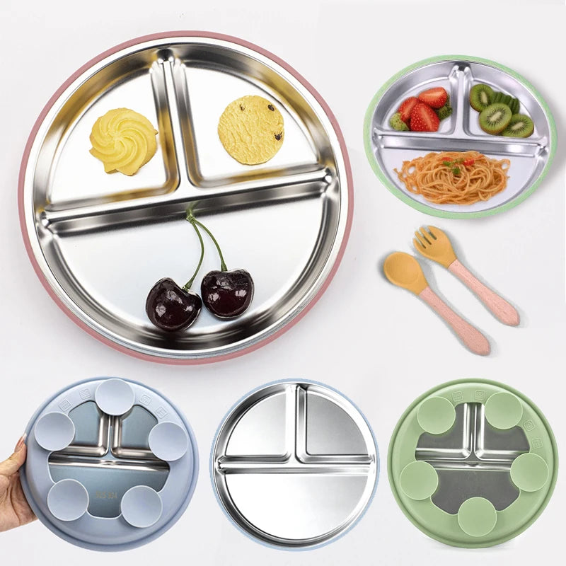 Set of stainless steel divided plates with food and utensils on a white background