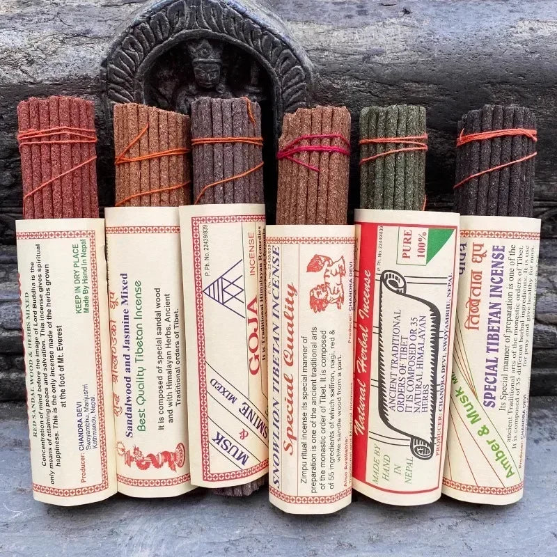 Collection of incense sticks with their packaging on a wooden background