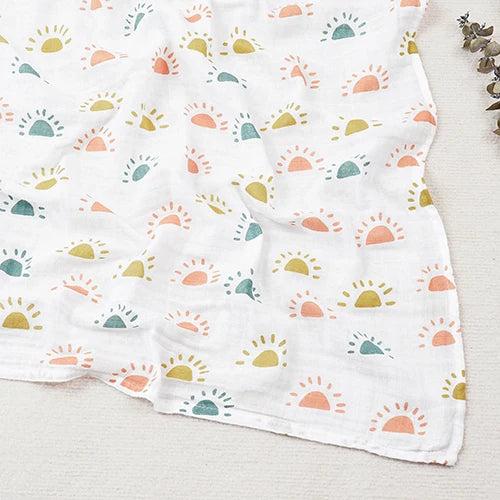 White fabric with colorful sun pattern on a light wooden surface