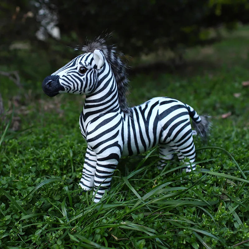 zebra plush toy on grass