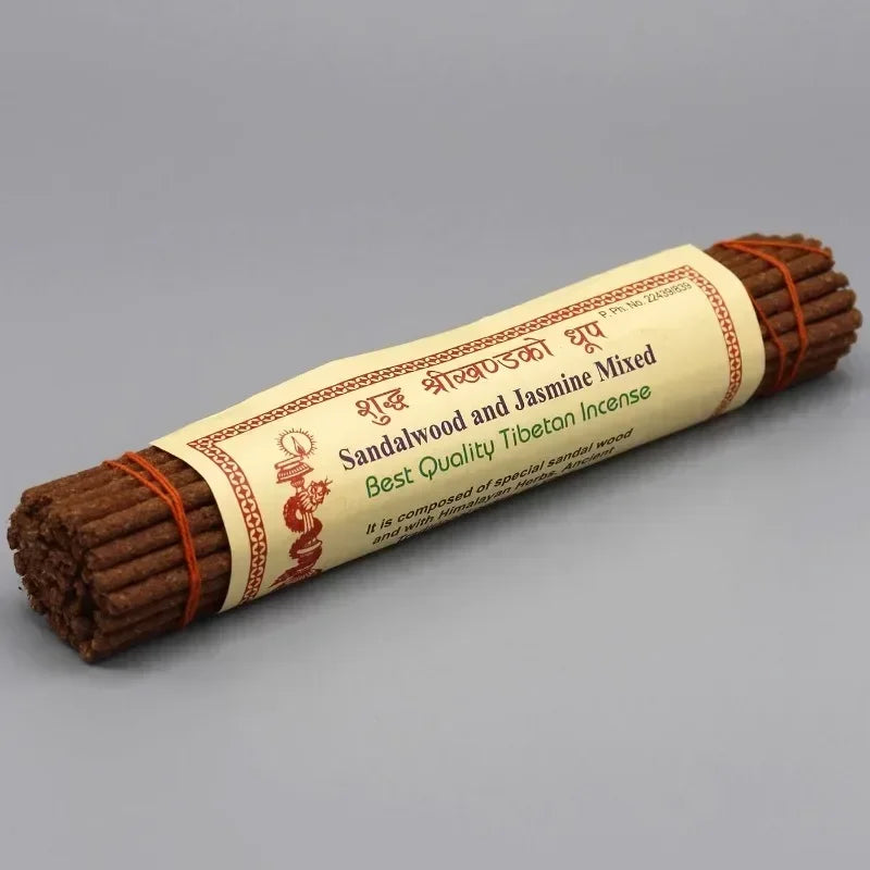 Roll of sandalwood and jasmine mixed incense with a label on a gray background