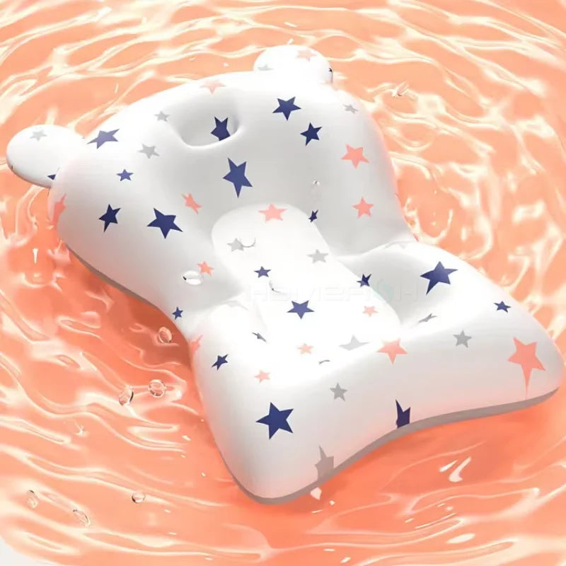 White baby pillow with star pattern on a pink and orange gradient background