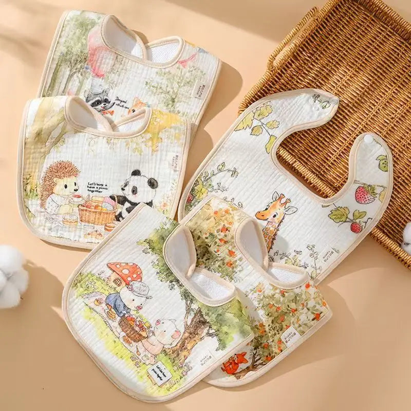 Set of baby bibs with animal illustrations on a beige background