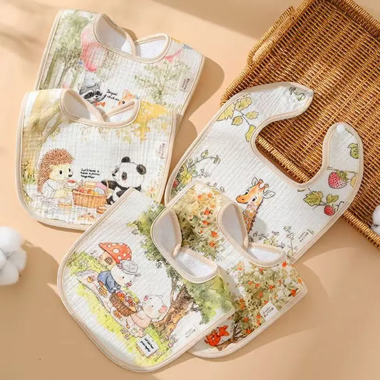 Set of baby bibs with animal illustrations on a beige background