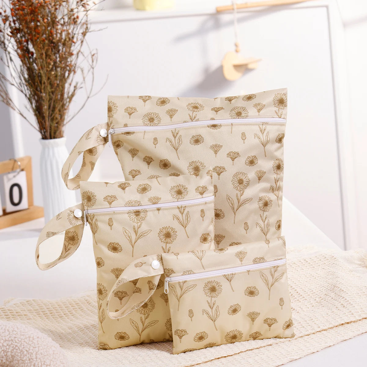Beige patterned bags with white zippers on a light surface