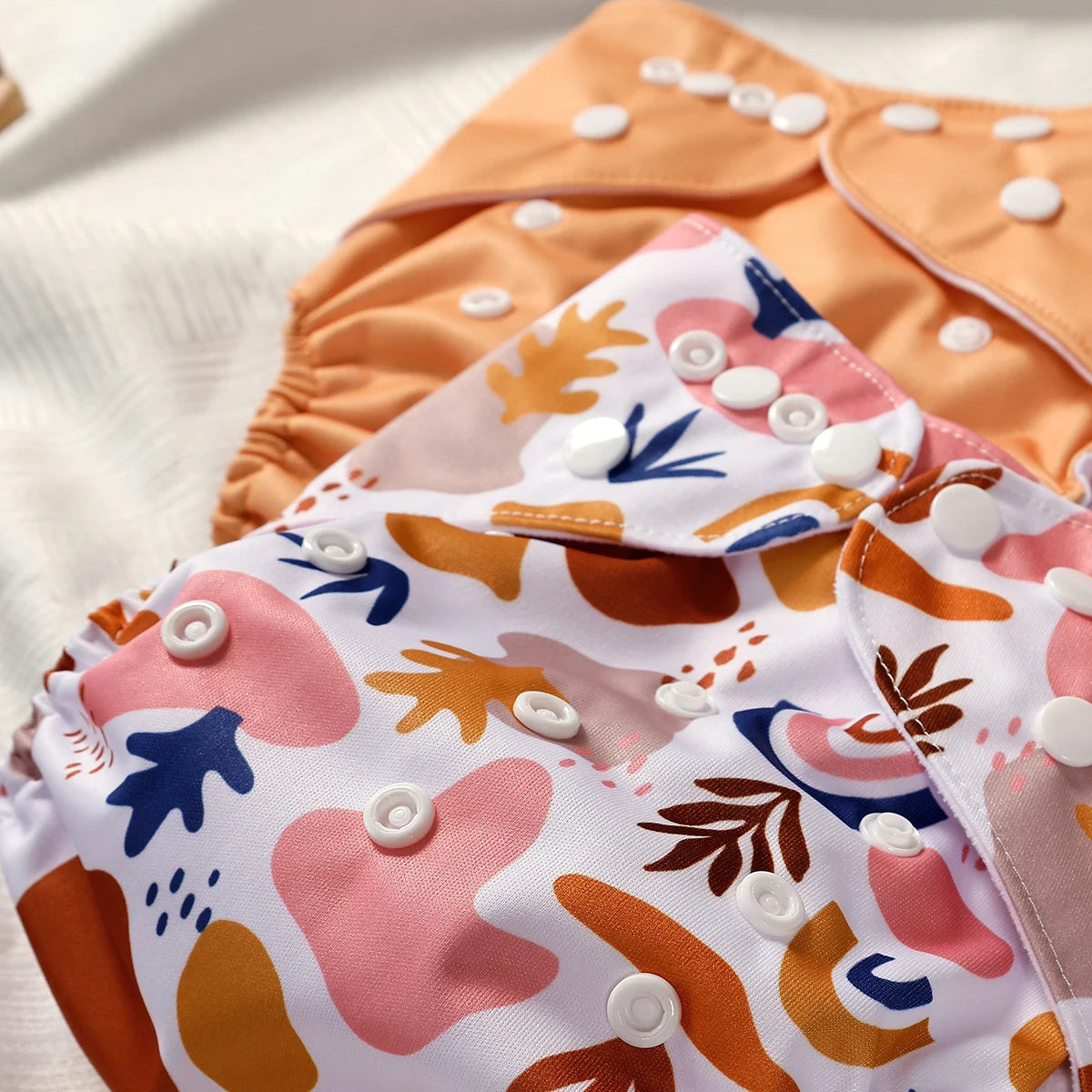 Patterned cloth diapers with floral design on a white background