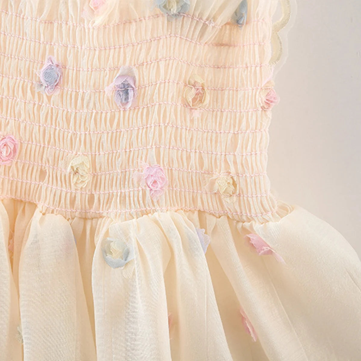 Pastel-colored dress with floral details on a light background
