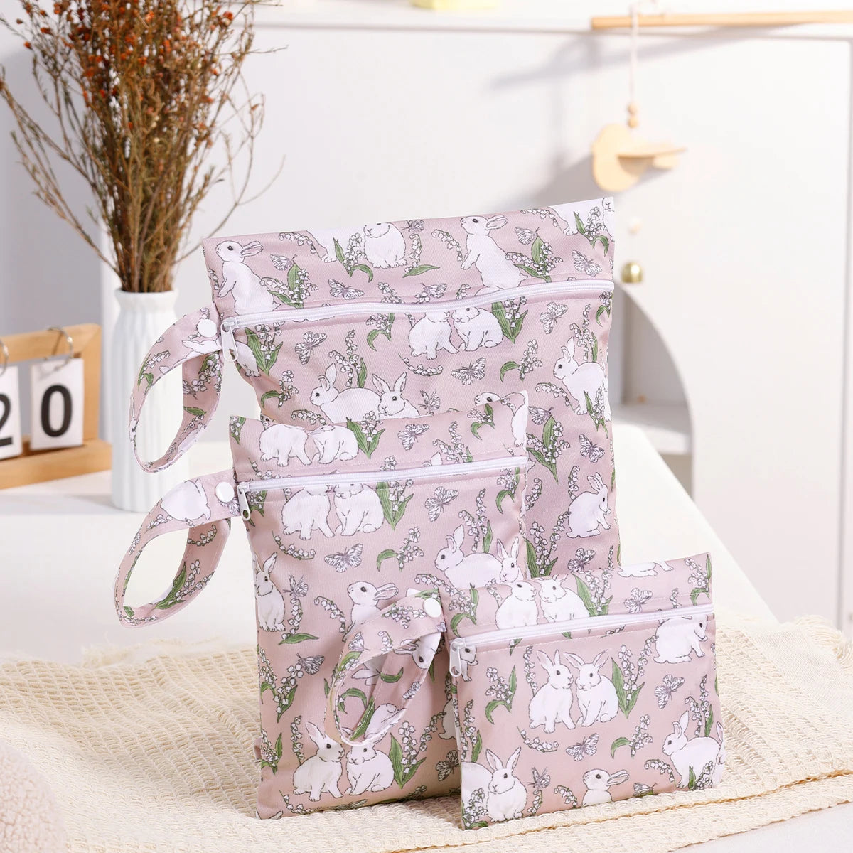 Set of three nappy bags with animal pattern on a light surface