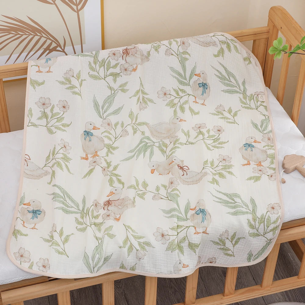 Floral and duck patterned towel draped over a crib