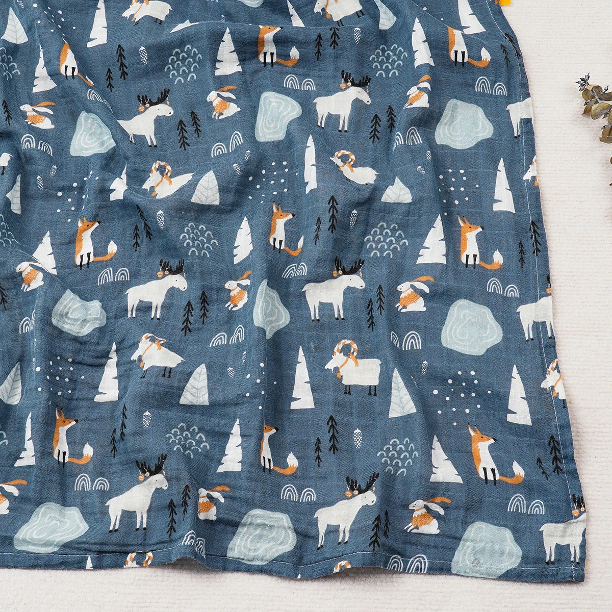 Fabric with a pattern of animals and nature elements on a blue background