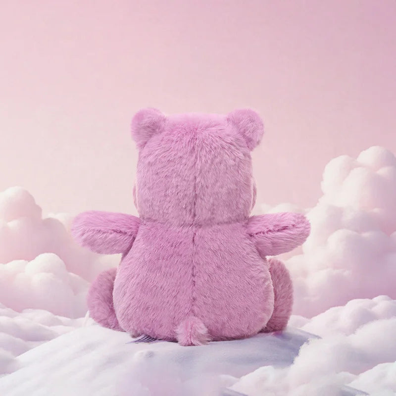 Pink teddy bear sitting on fluffy clouds against a pink background