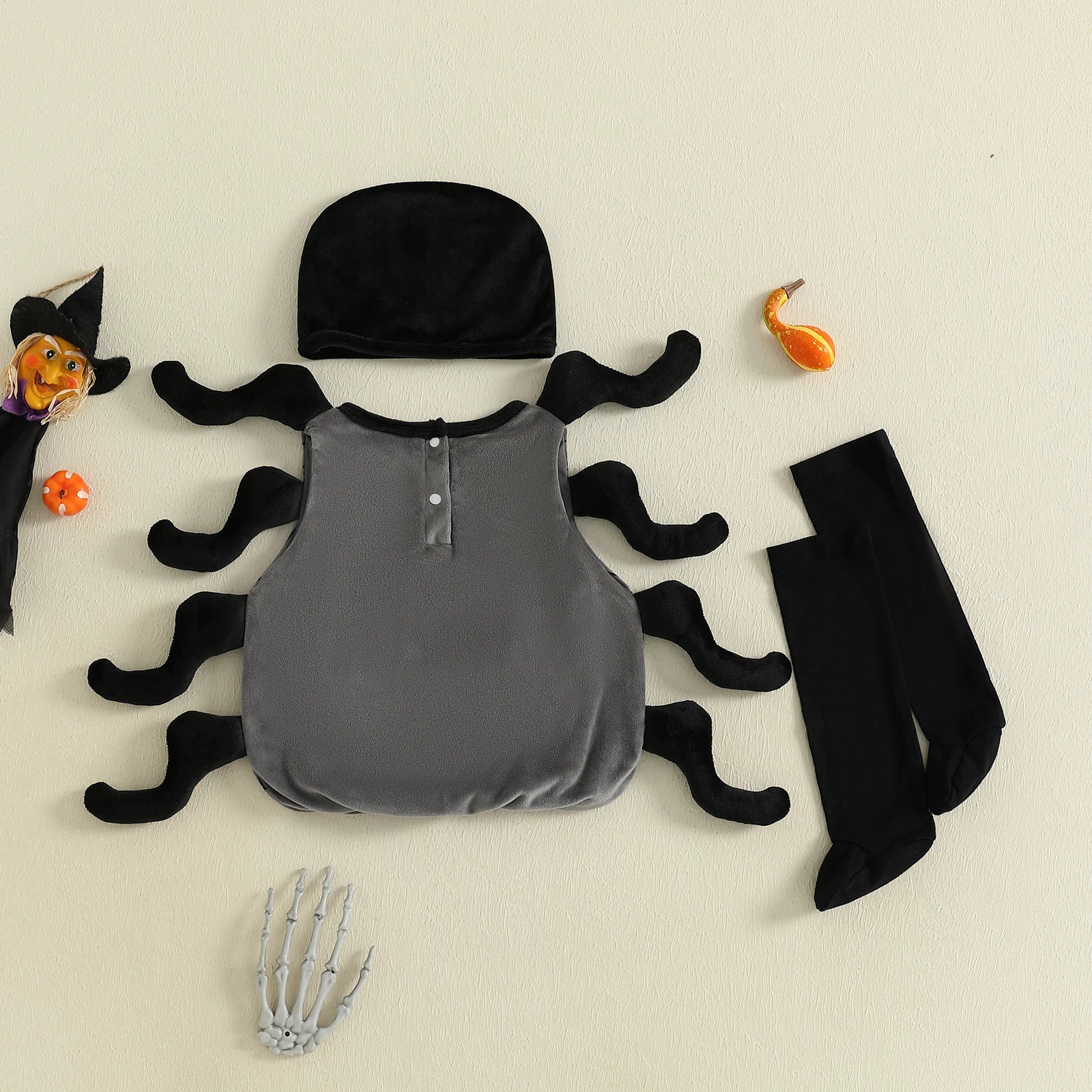 Halloween costume set with gray shirt, black hat, and black mustache-like accessories on a beige background.