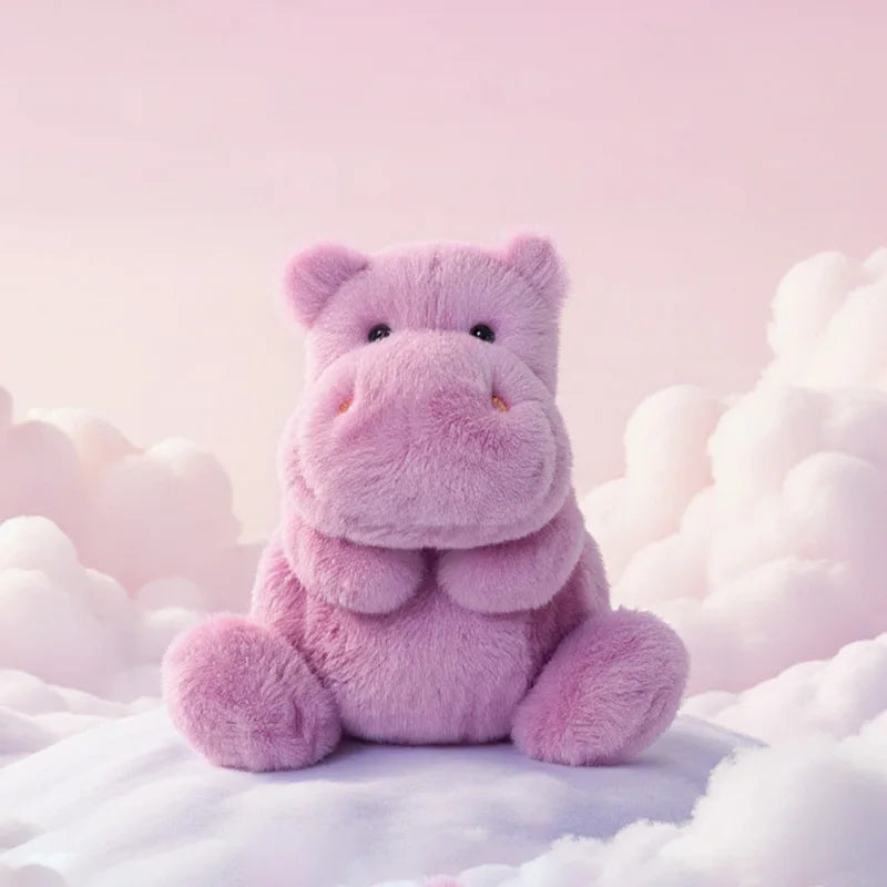 Pink hippo sitting on fluffy white clouds with a soft pink background