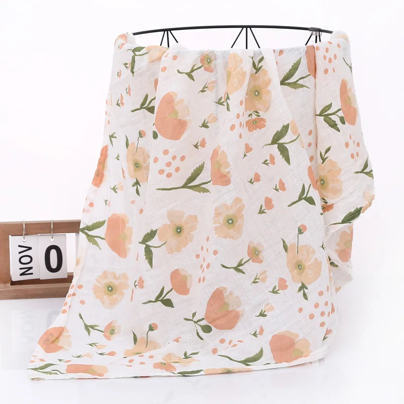 Floral patterned baby blanket draped over a rod with a calendar in the background