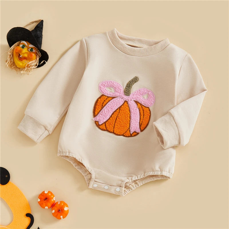 Baby romper with pumpkin design on a beige background
