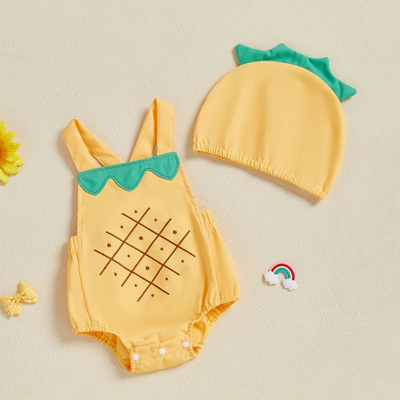 Yellow pineapple-themed baby romper and hat set on a beige background