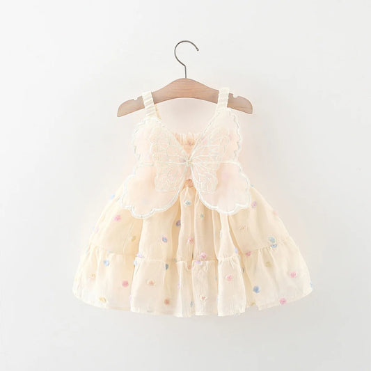 Beige dress with colorful polka dots on a wooden hanger against a white background