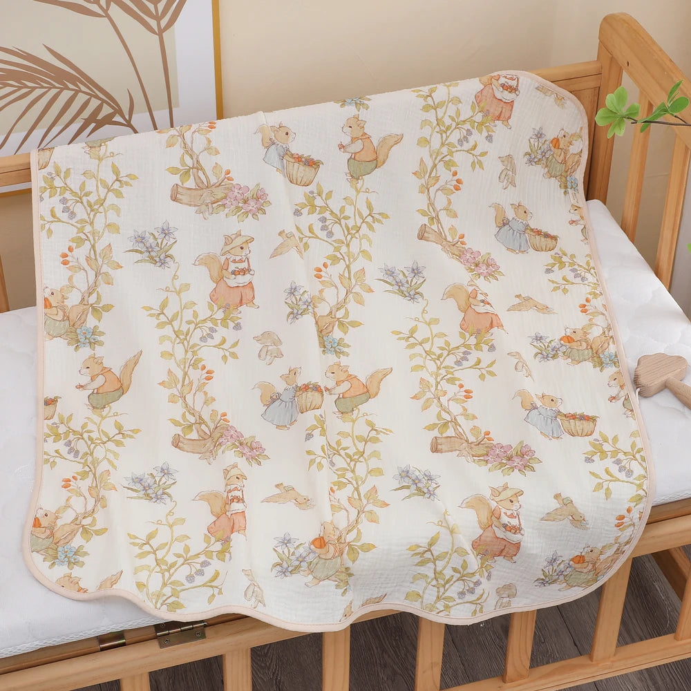 Baby crib with a floral and animal patterned blanket