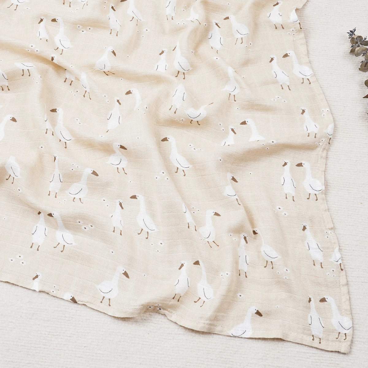 Fabric with a pattern of white birds on a beige background