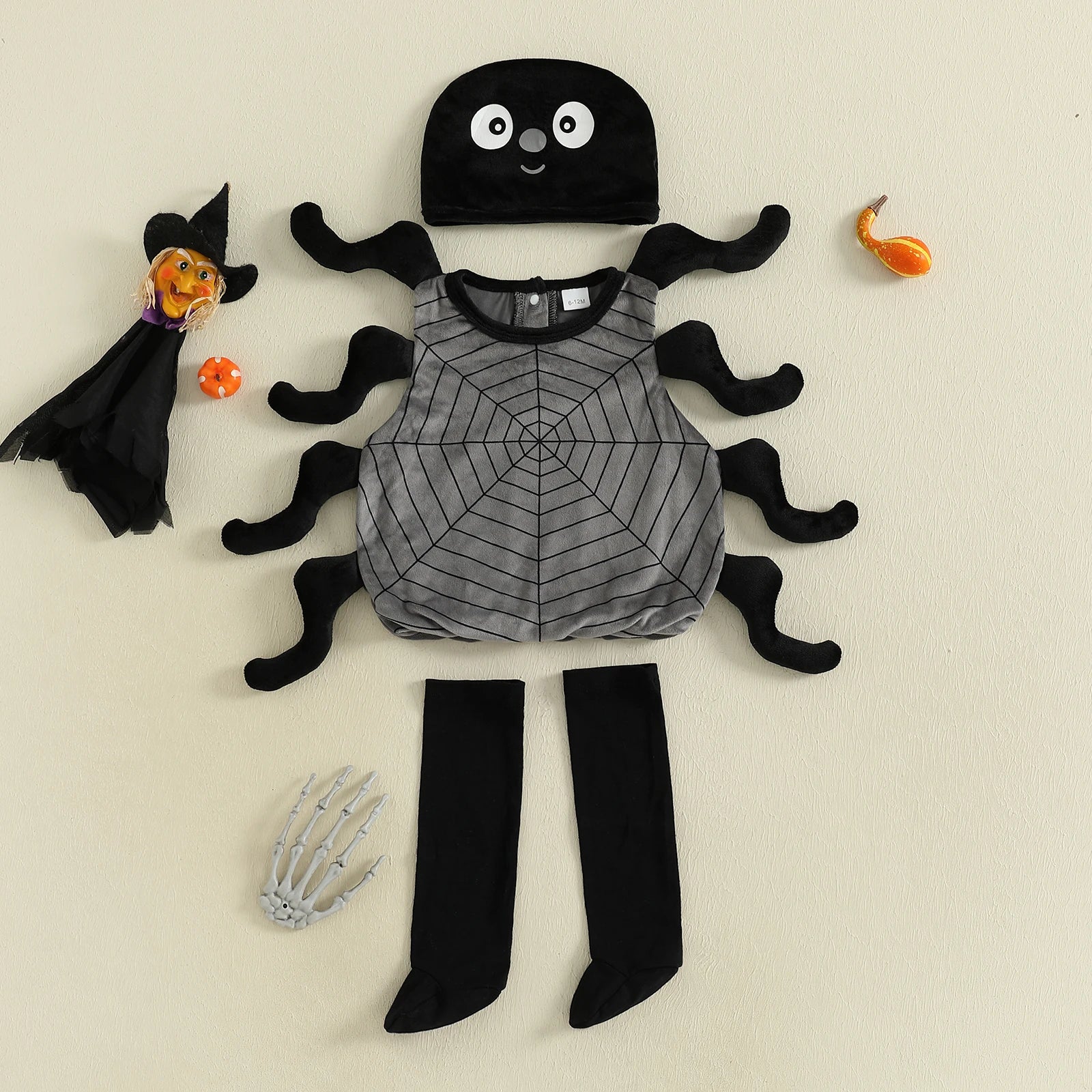 Children's Halloween costume with spider design on a beige background
