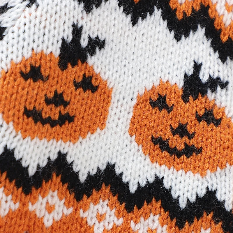 Knitted fabric with Halloween-themed pattern featuring pumpkins.