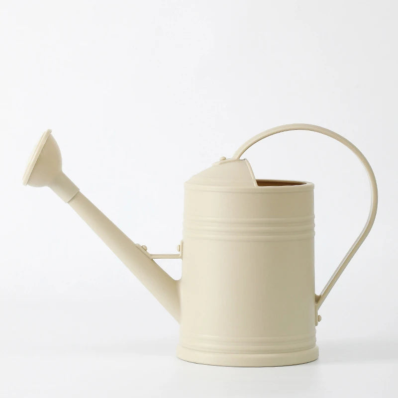 Beige watering can on a white background