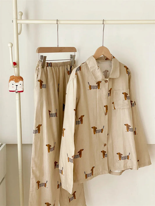 Beige outfit with dog pattern on hangers against a white background
