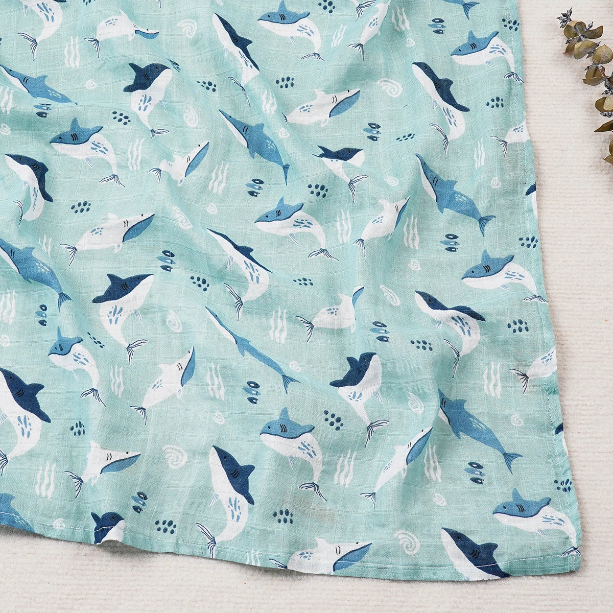 baby blanket with shark pattern on a light blue background