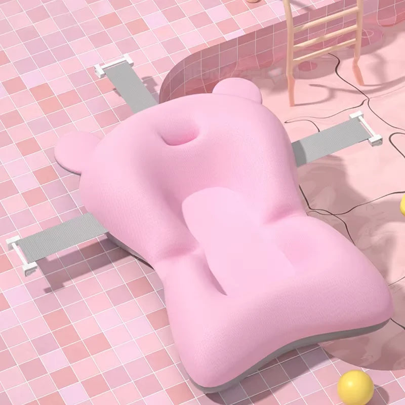 Pink bathtub pillow on a tiled bathroom floor with a yellow ball and bathtub in the background.