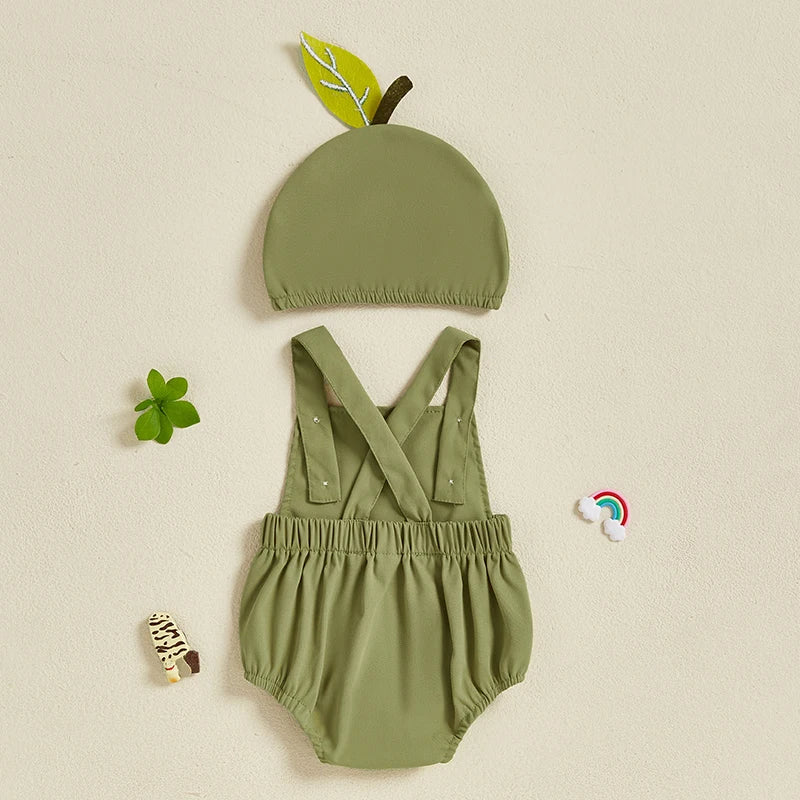 Green baby romper with matching hat on a beige background