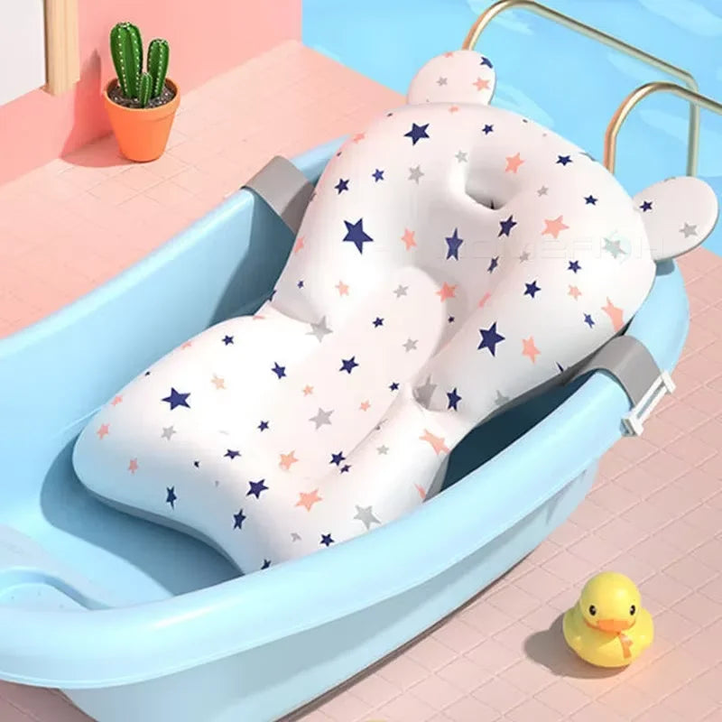 Baby bathtub with a star-patterned bath pillow and a yellow rubber duck on a colorful background.