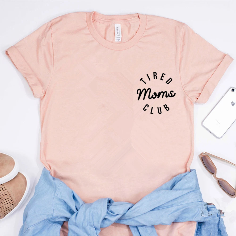 Pink t-shirt with 'Tired Moms Club' text on a white background