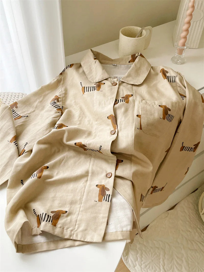 Beige shirt with dog pattern on a white surface