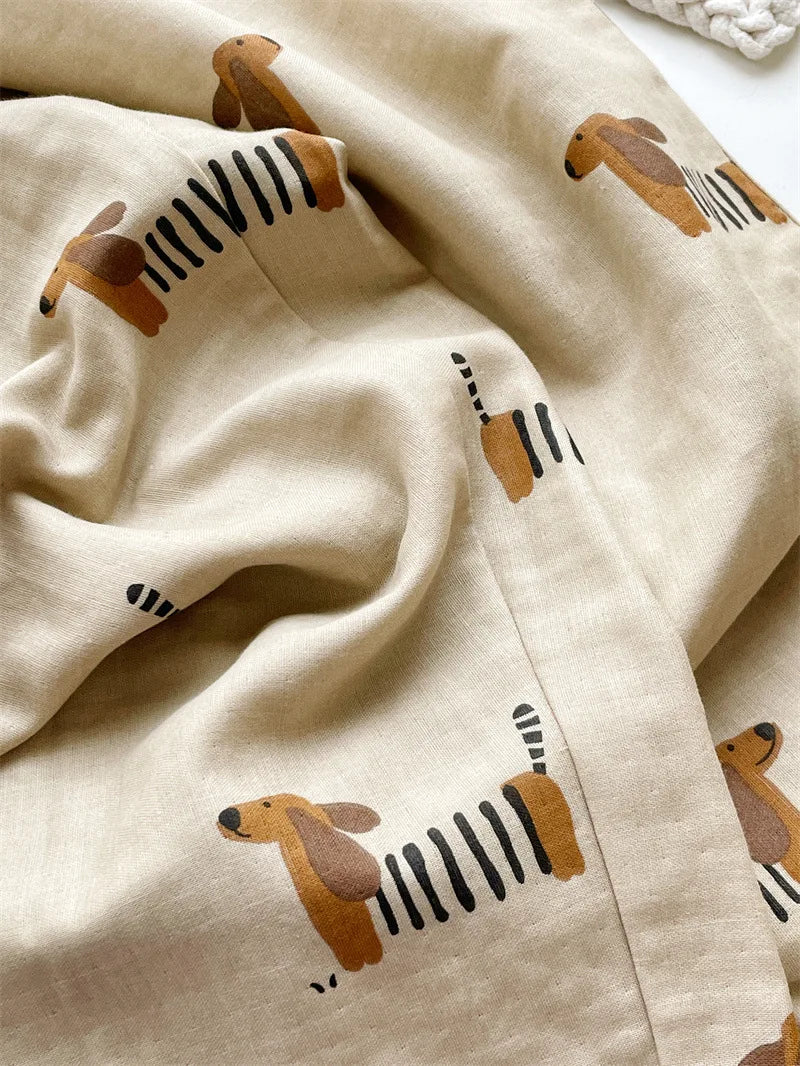 Beige fabric with cartoon dog illustrations on a white background