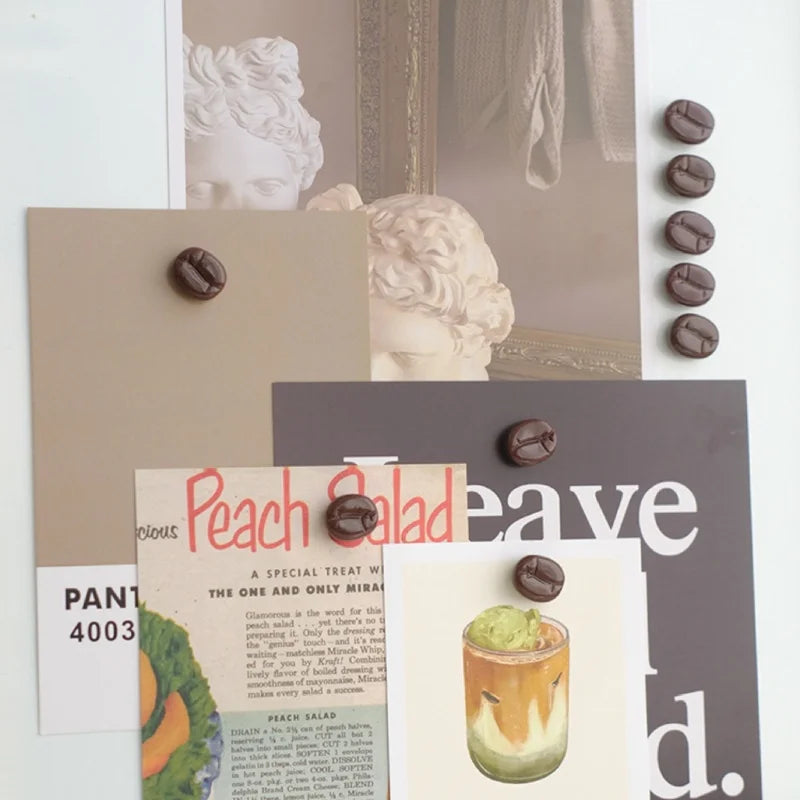 Collage of coffee bean magnets on a magazine with a coffee-themed layout