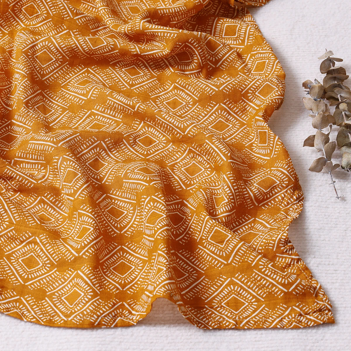 Yellow fabric with a geometric pattern on a white background