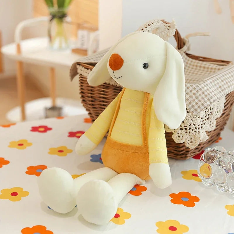 Plush toy rabbit in a yellow outfit on a floral-patterned surface with a blurred background