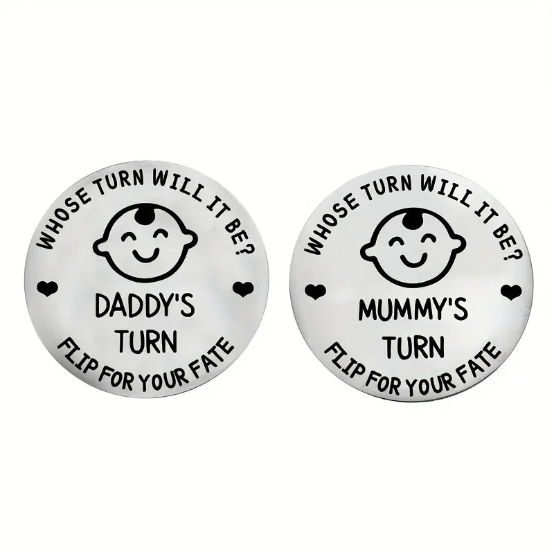 Two round metal tokens with humorous text and baby face design on a white background.