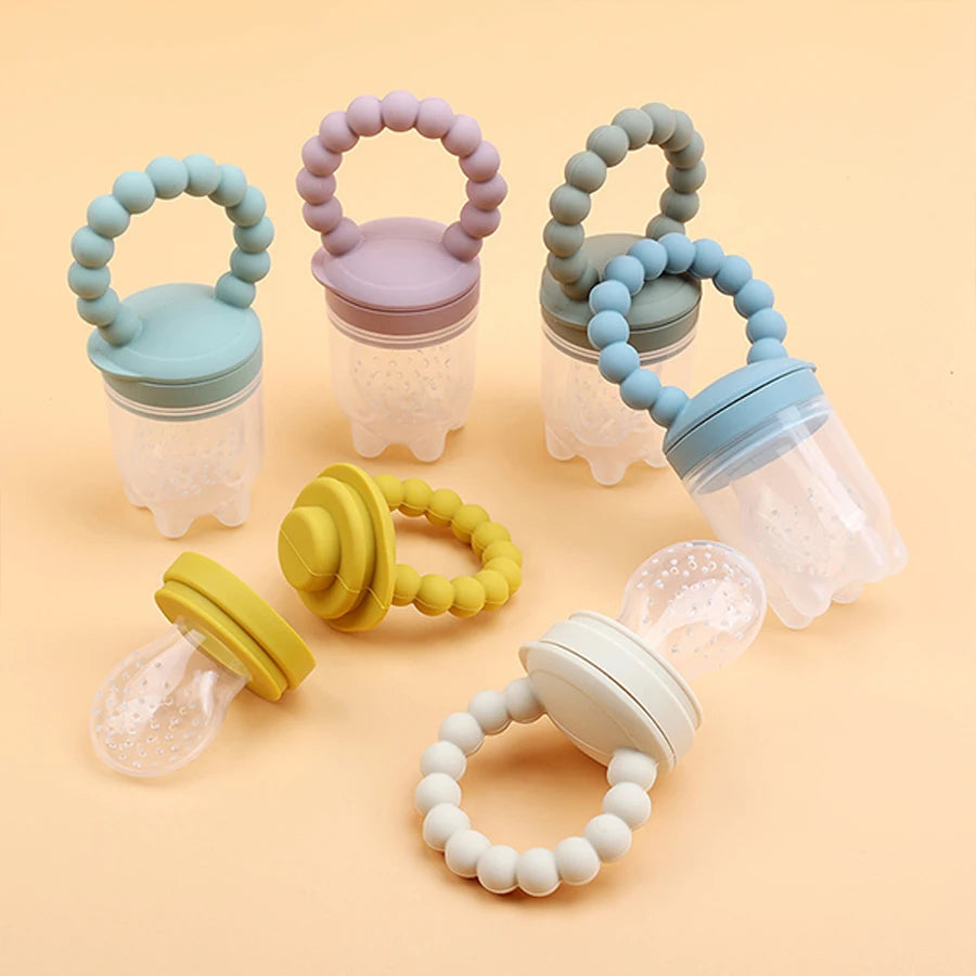 Set of colorful baby teething toys on a beige background