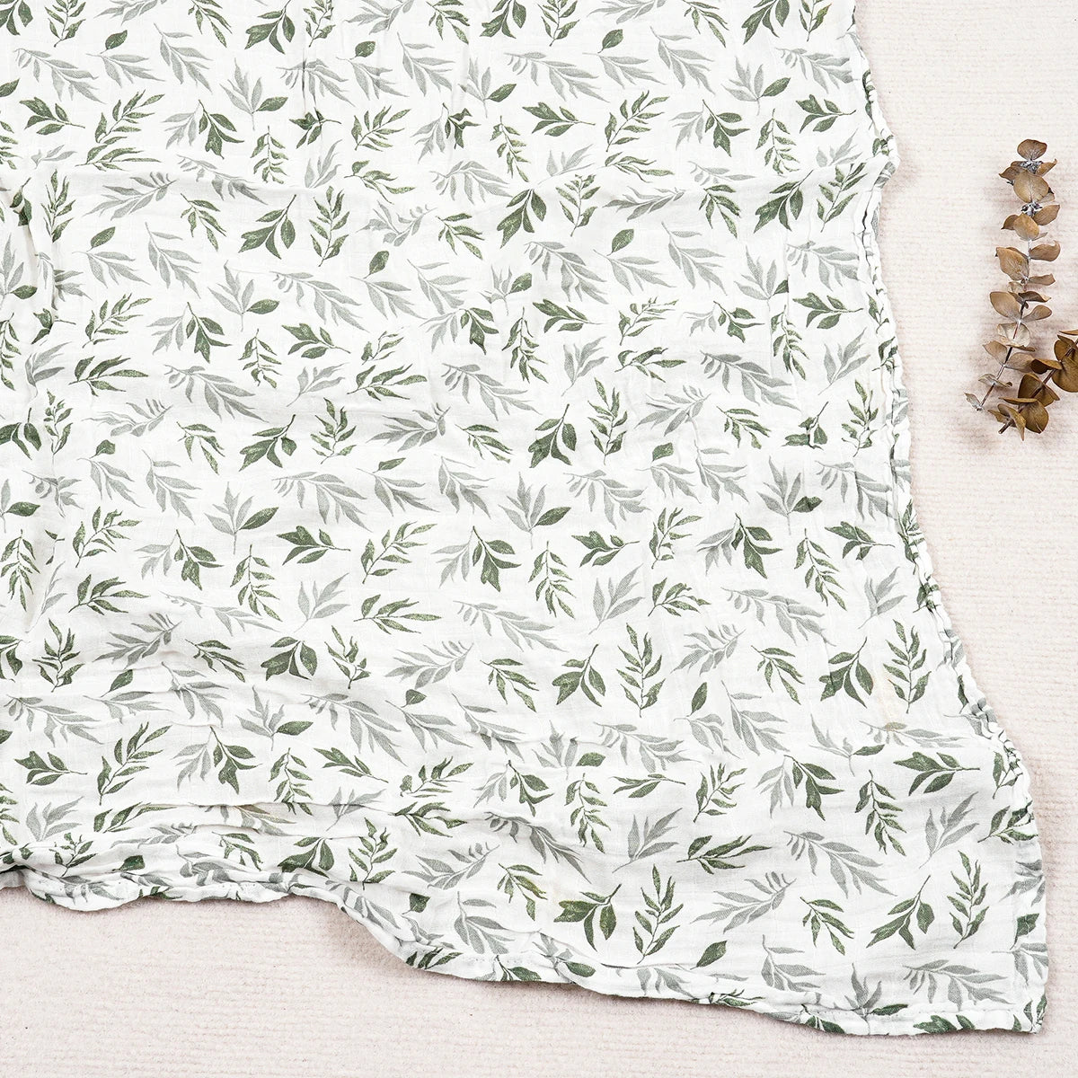 Fabric with green leaf pattern on a white background