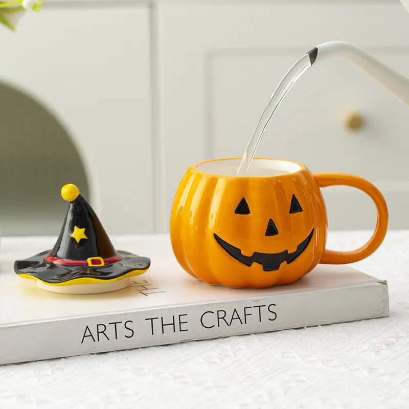 Pumpkin-shaped mug with a witch hat on a book titled 'Arts The Crafts'.