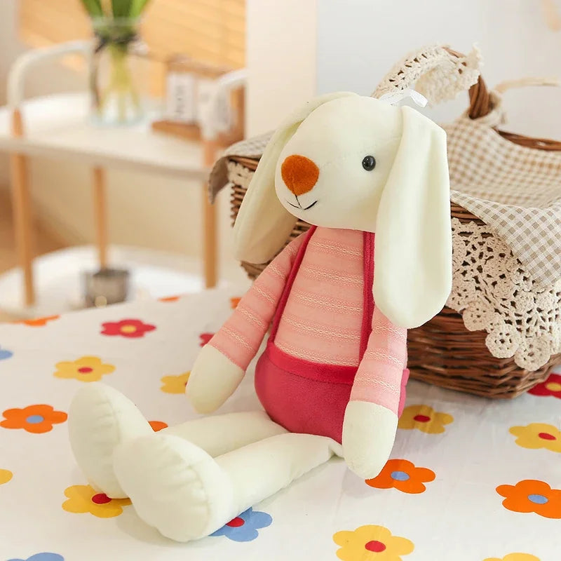 Plush rabbit toy on a floral blanket with a blurred indoor background